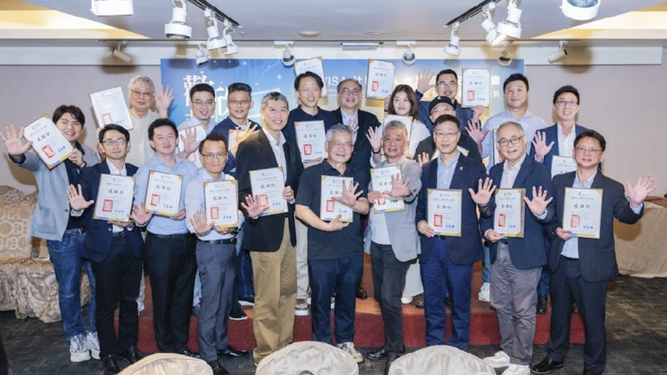 Group photo of attendees holding documents